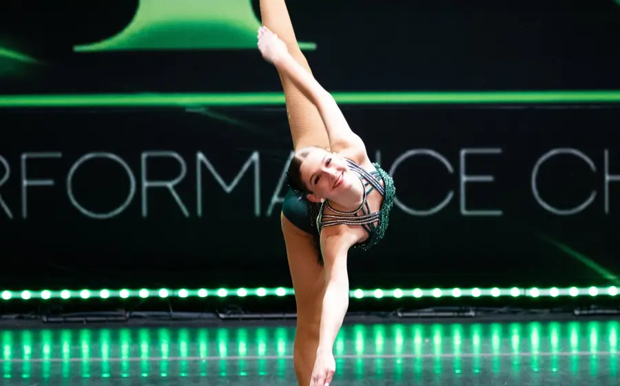 A dancer in a white dress performing on the DPC stage
